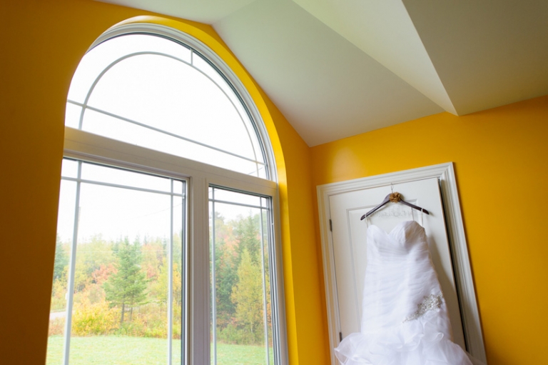 Wedding dress hanging by window