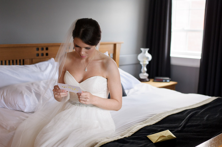 Bride on bed reading letter from groom
