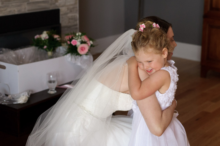 Bride hugging flower girl