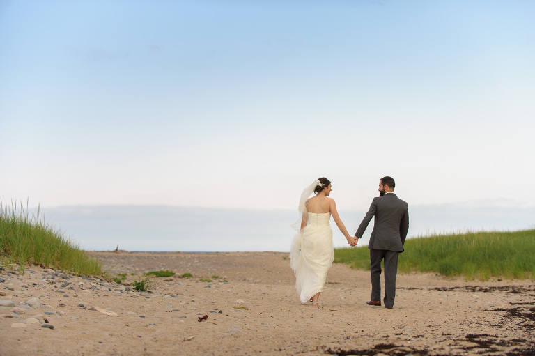 Bride and groom walking on the beach - Cape Breton