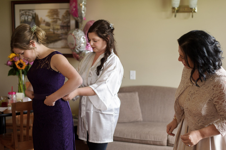 bride helping maid of honor