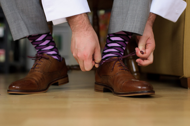 groom tying shoes