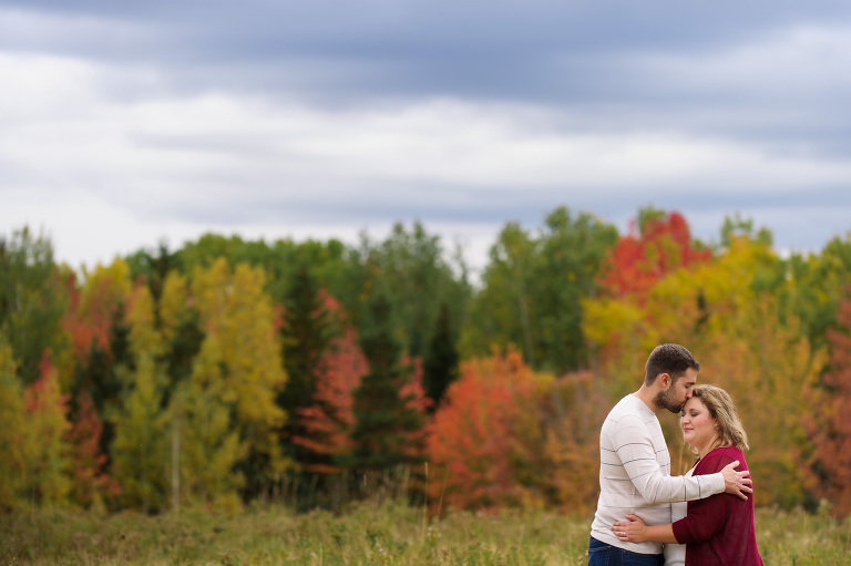 Engaged couple in field