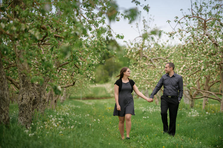 Couple walking in apple orchard