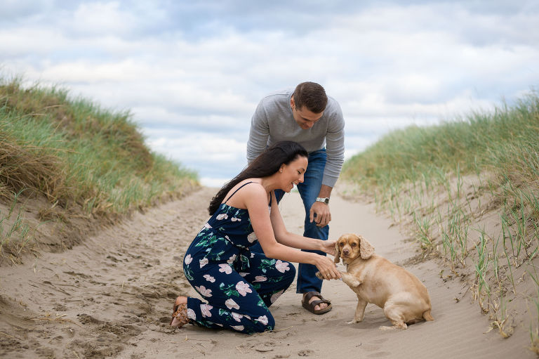 Couple on the beach with dog