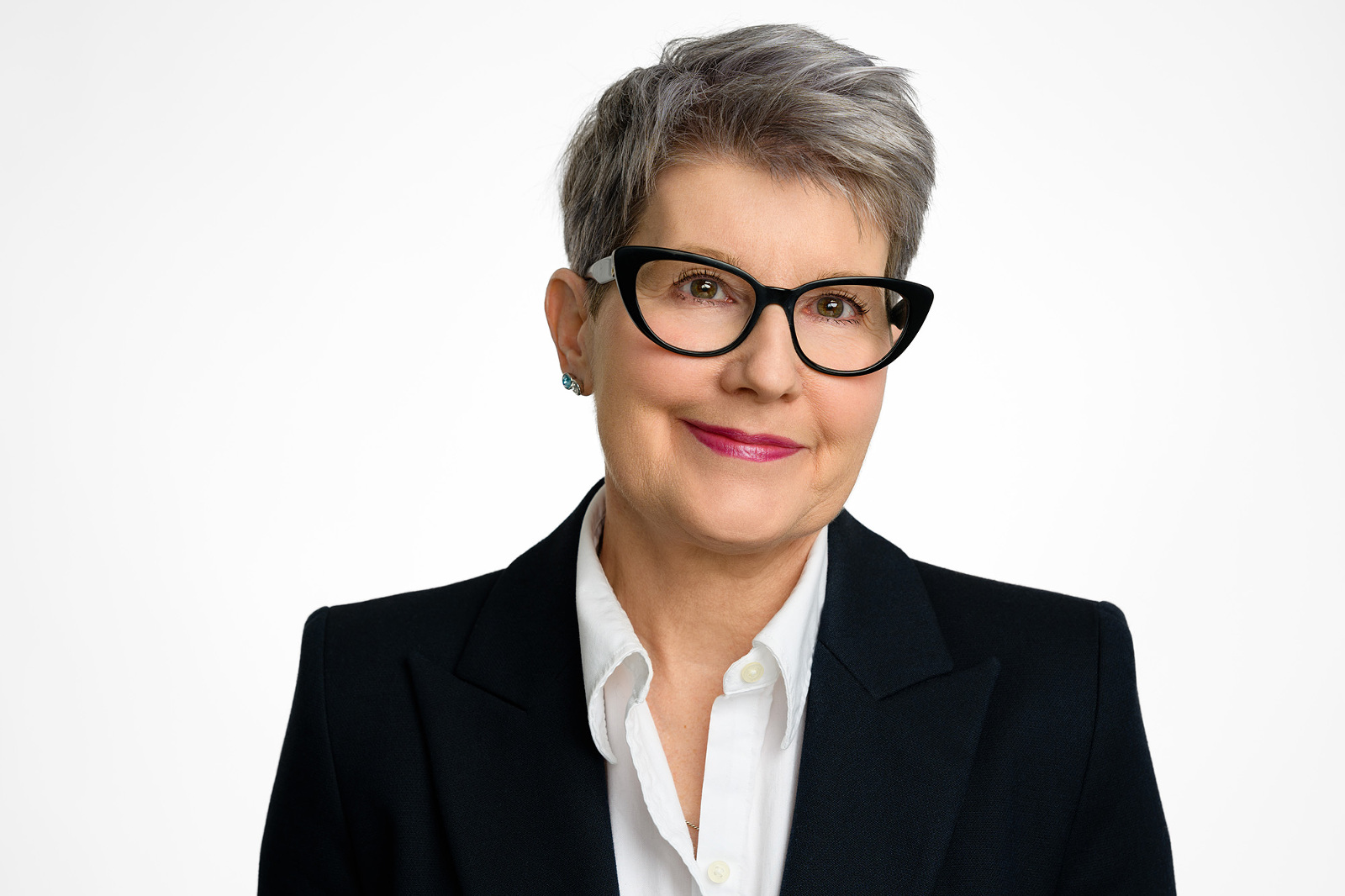 Headshot of mature woman wearing glasses on white background